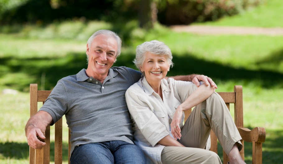 Senior couple sitting on a bench in the park